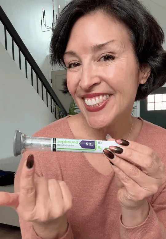 Smiling patient holding an injection pen